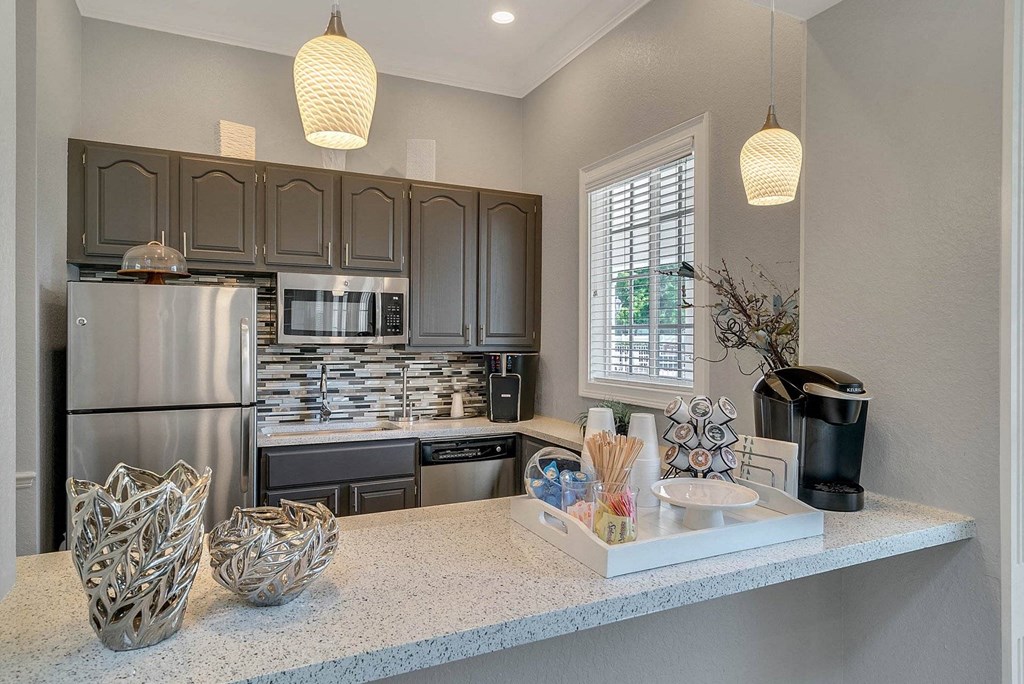 A kitchen with a refrigerator, microwave, and oven at The Villages on Millenia Apartments, Florida, 32839