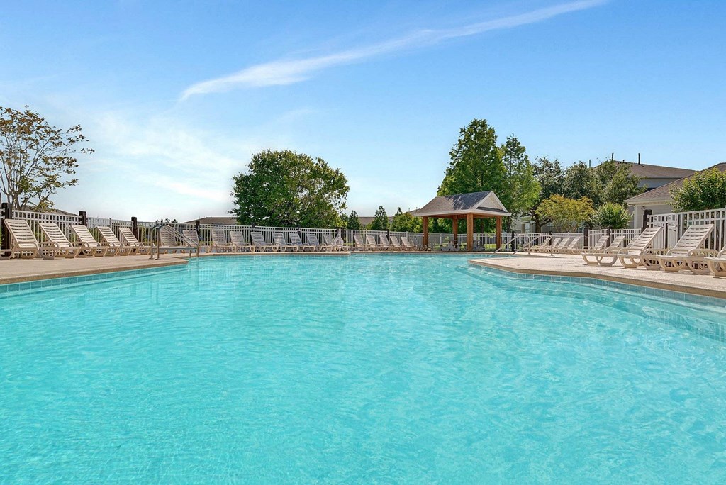 A large swimming pool with a gazebo in the background at The Villages on Millenia Apartments, Orlando, FL