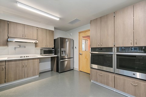 A kitchen with wooden cabinets and stainless steel appliances.
