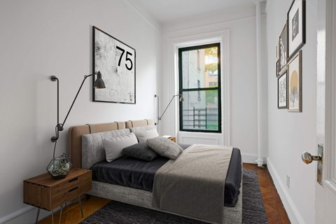 A bedroom with a bed, nightstand, and a picture frame on the wall.