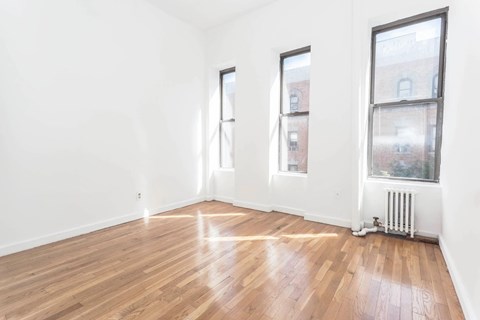 A room with wooden floors and white walls.