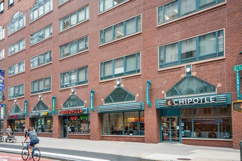 A Chipotle restaurant is located in a brick building.