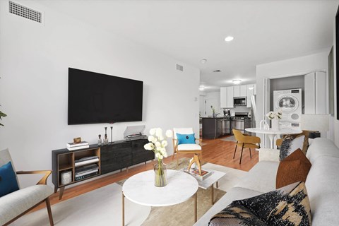 A modern living room with a flat screen TV mounted on the wall.