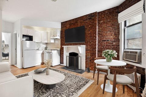 A living room with a fireplace and a television on the wall.