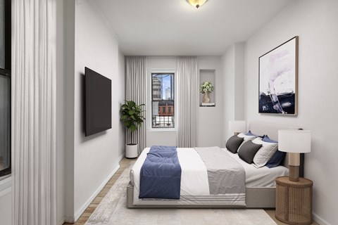 A bedroom with a large bed and a flat screen TV mounted on the wall.