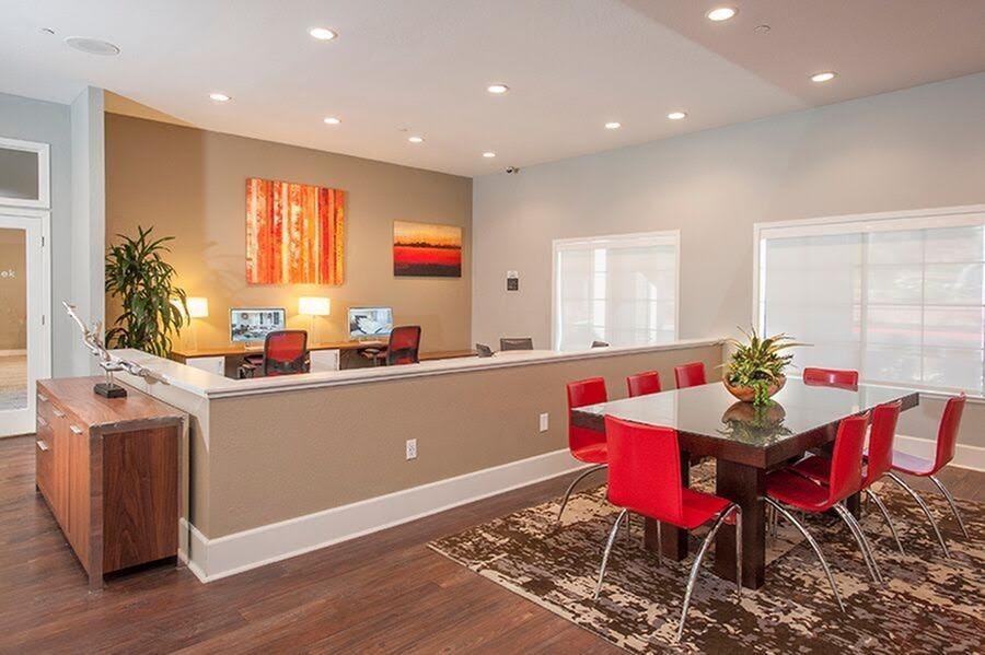A dining room with a table set for four.