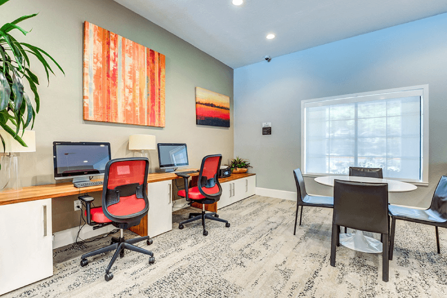 A room with a desk, chairs, and a computer at Kirker Creek Apartments, Pittsburg, CA, 94565