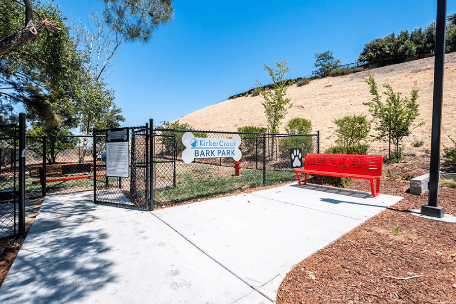 Outdoor patio with red bench at Kirker Creek Apartments, California, 94565