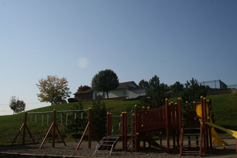 A playground with a yellow caution tape around it.