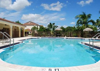Pool with lounge chairs Eagles Pointe in Pompano Beach Florida