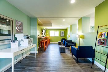 a living room with green walls and blue and yellow furniture at Mountain Run Apartments, Utah