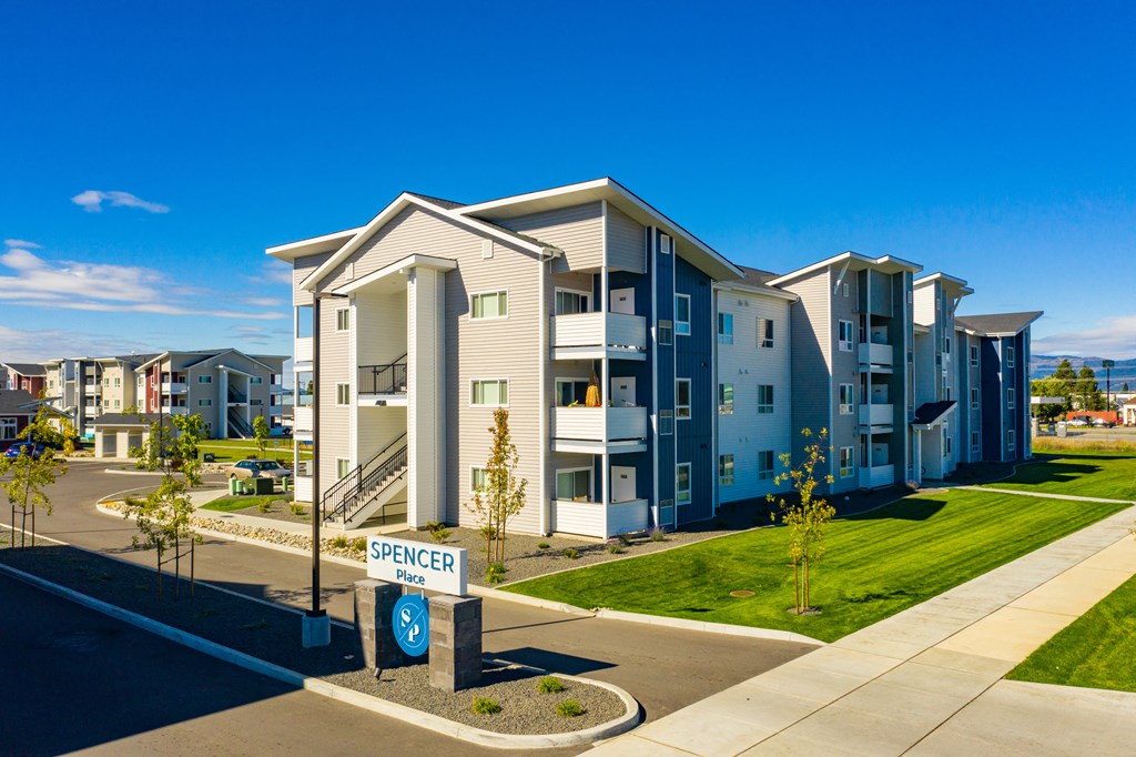 new apartment buildings on the side of a street