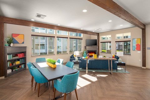 a living room and dining room with a table and chairs