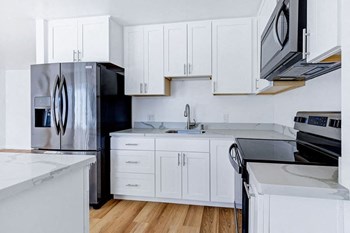 kitchen with white cabinets and appliances - Photo Gallery 19