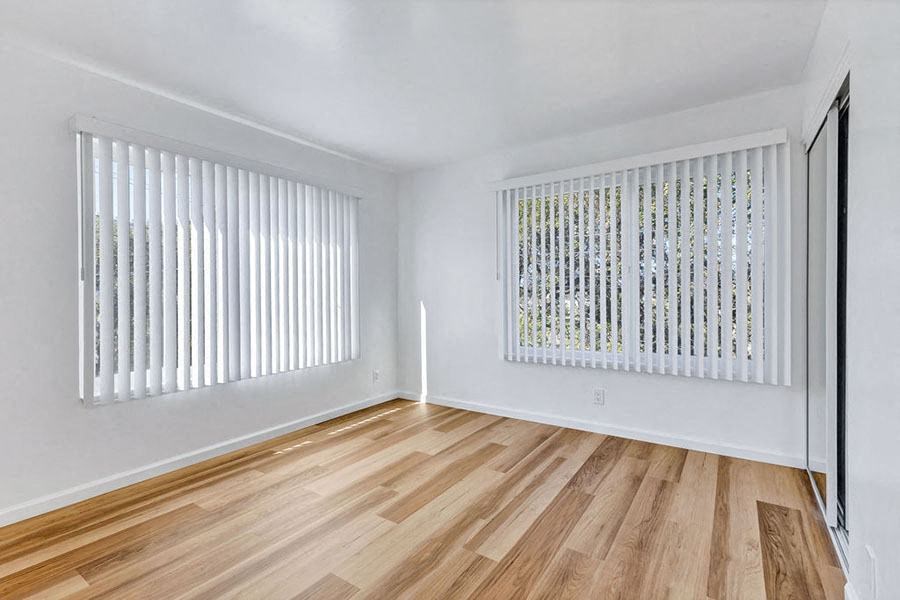 Bedroom with wood floors and windows