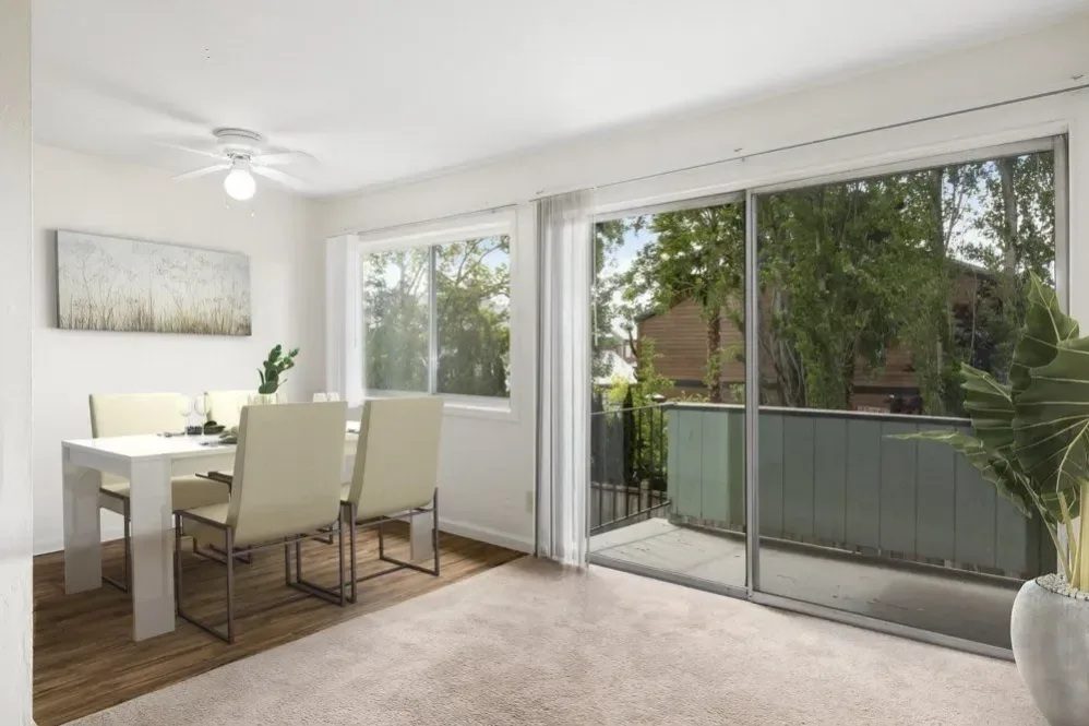 A dining room with a table and chairs.