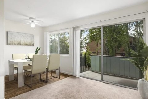 A dining room with a table and chairs.