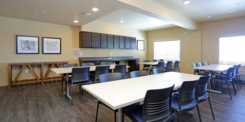 A large conference room with a long table and chairs.