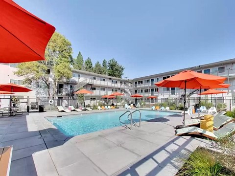 pool area with umbrellas and lounge seating at THE POST Apartments, PLEASANT HILL 