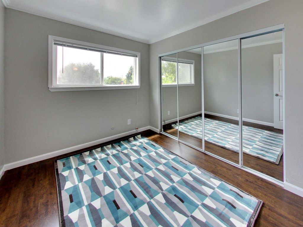 The Post Apartments bedroom with mirrored closet doors