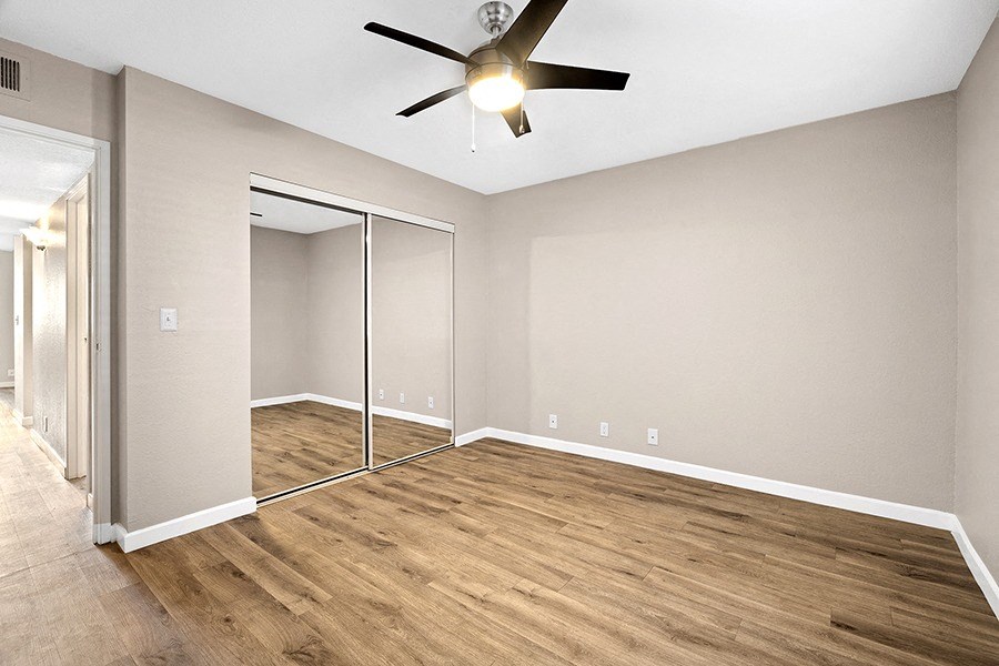 Bedroom with wood floor and closet