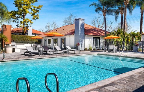 Pool with lounge chairs and umbrellas