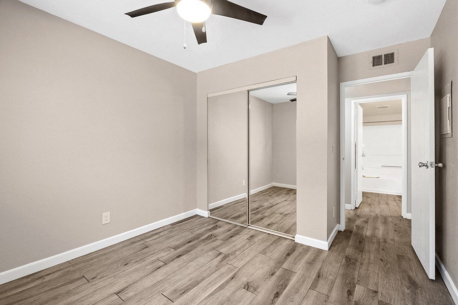 Bedroom with wood floor and closet