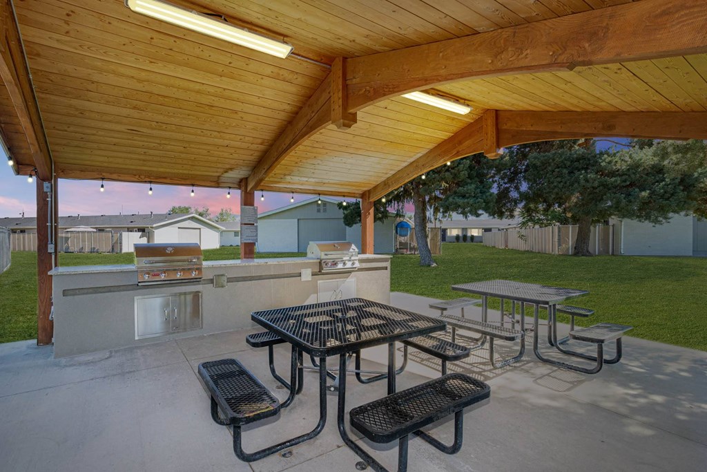 a patio with picnic tables and a grill at Cadence Apartments, Utah, 84067