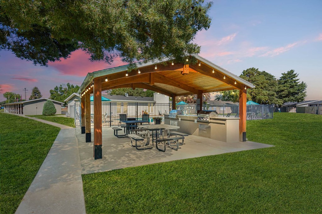 a patio with a picnic table and a pavilion with lights at Cadence Apartments, Utah