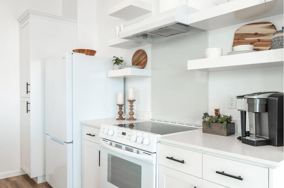 a kitchen with white cabinets and white appliances