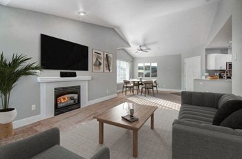 Dupont Apartments- Clock Tower Village- High Ceilings with Fireplace and Comfortable Grey Couch - Photo Gallery 3