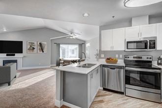 Dupont, WA Apartments- Clock Tower Village- Stainless-Steel Appliances with Quartz Countertops and White Cabinets