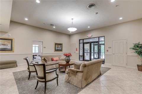 a living room with couches and chairs and a door