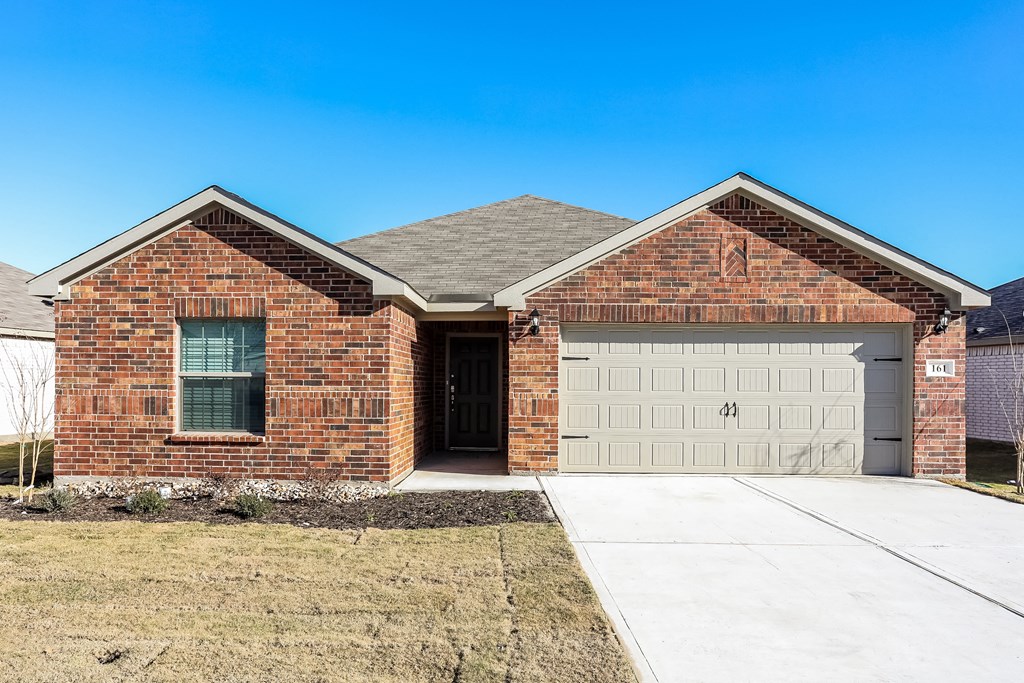 a brick house with a white garage door