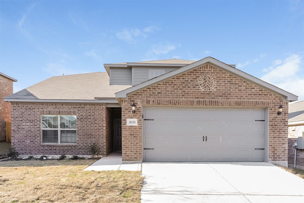 a brick house with a white garage door
