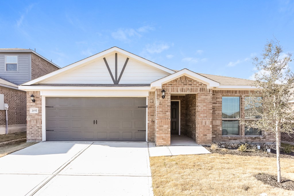 a house with a driveway and a garage door