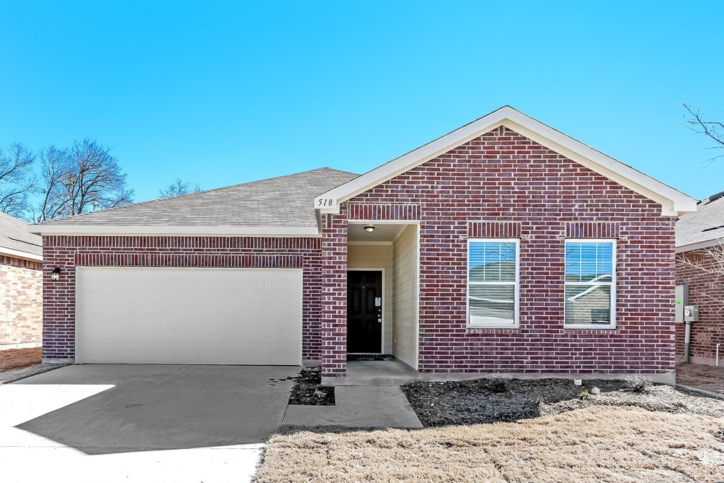 a red brick house with a white garage door