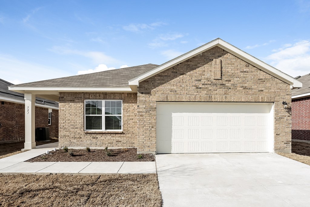 a brick house with a white garage door