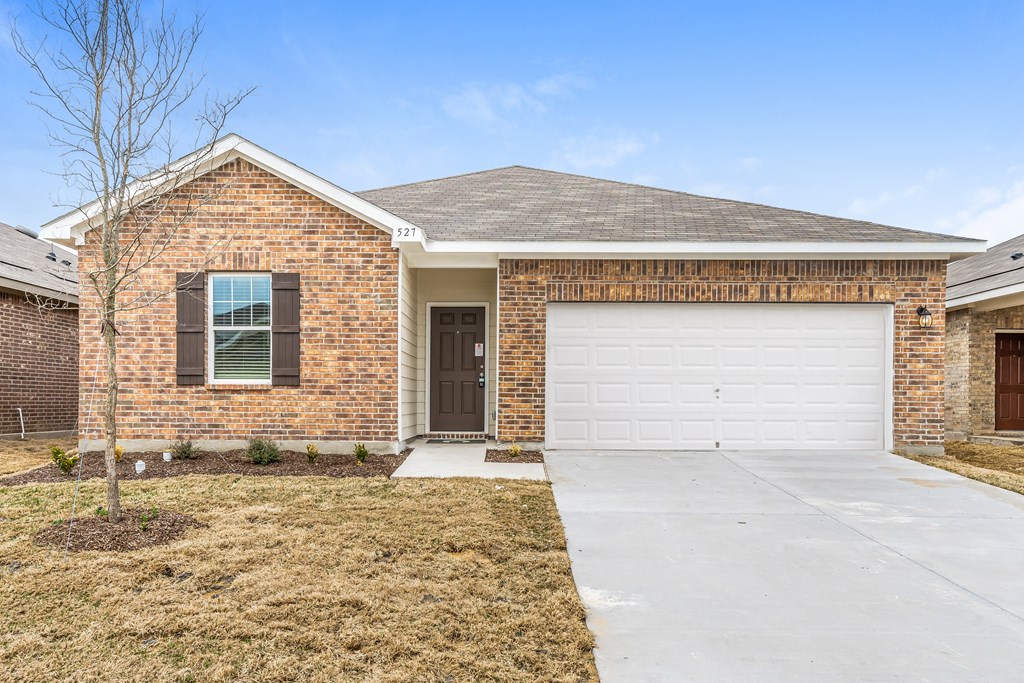 a brick house with a white garage door