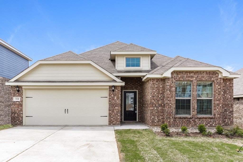 a brick house with a white door and a driveway