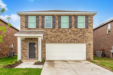 Three and Four-BR Houses for Rent in Forney TX - Windmill Farms - Exterior View of Two-Story Brick House with Two-Car Garage