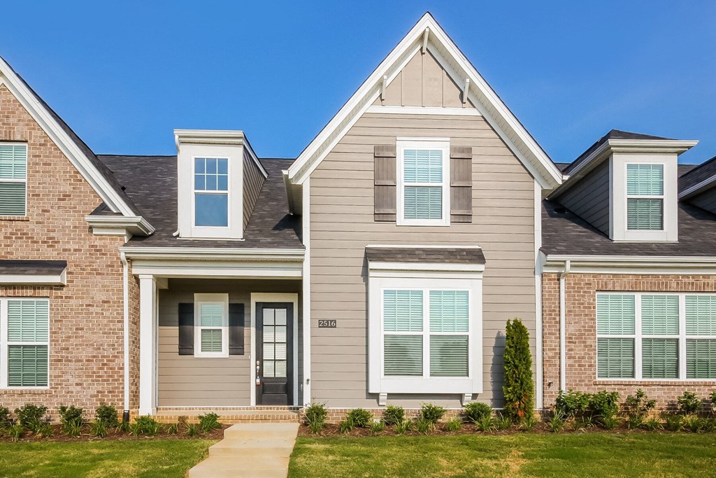 the exterior of a home with brick and siding