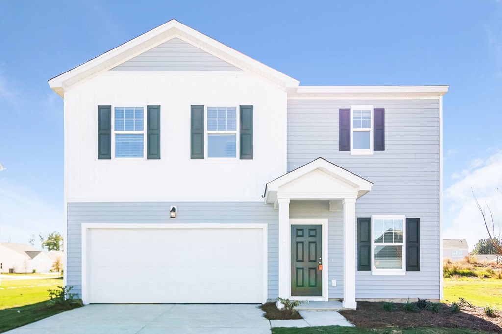 a white house with blue shutters and a driveway