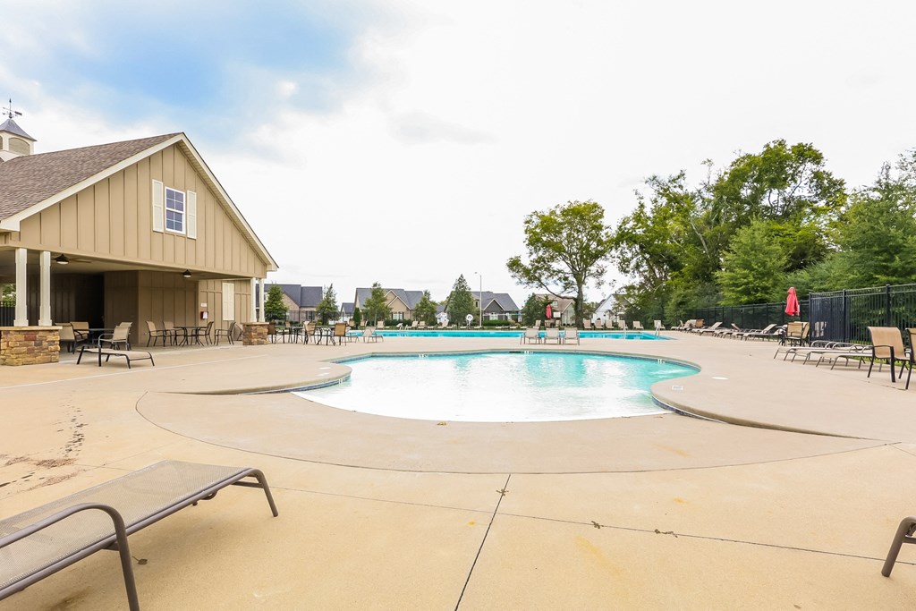 the swimming pool at our community center with chairs around it