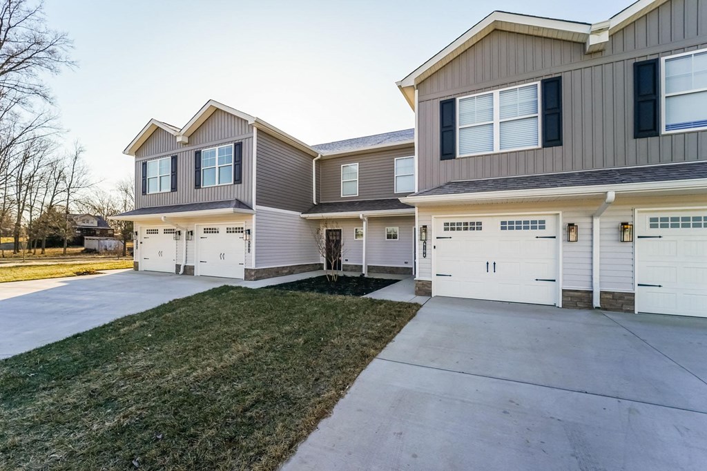 a house with a driveway and two garage doors