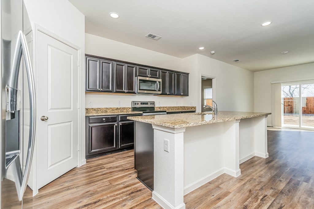 a kitchen with black appliances and a counter top