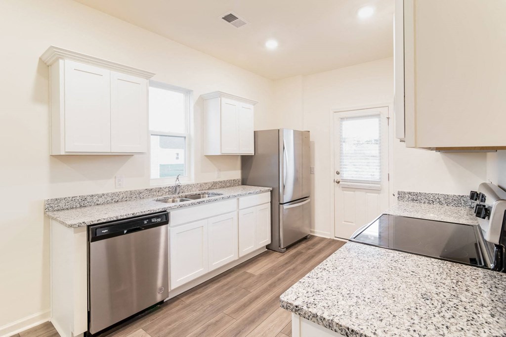 a kitchen with granite counter tops and stainless steel appliances