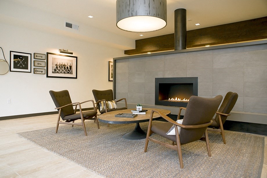 a living room with a fireplace and a table and chairs