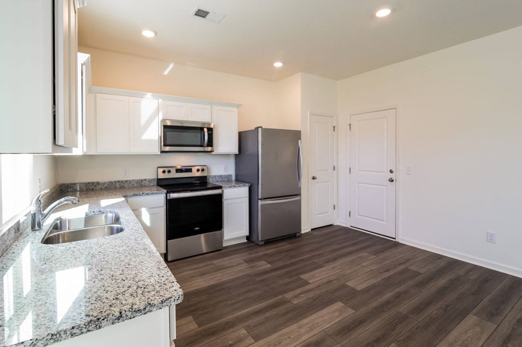 a kitchen with stainless steel appliances and a granite counter top