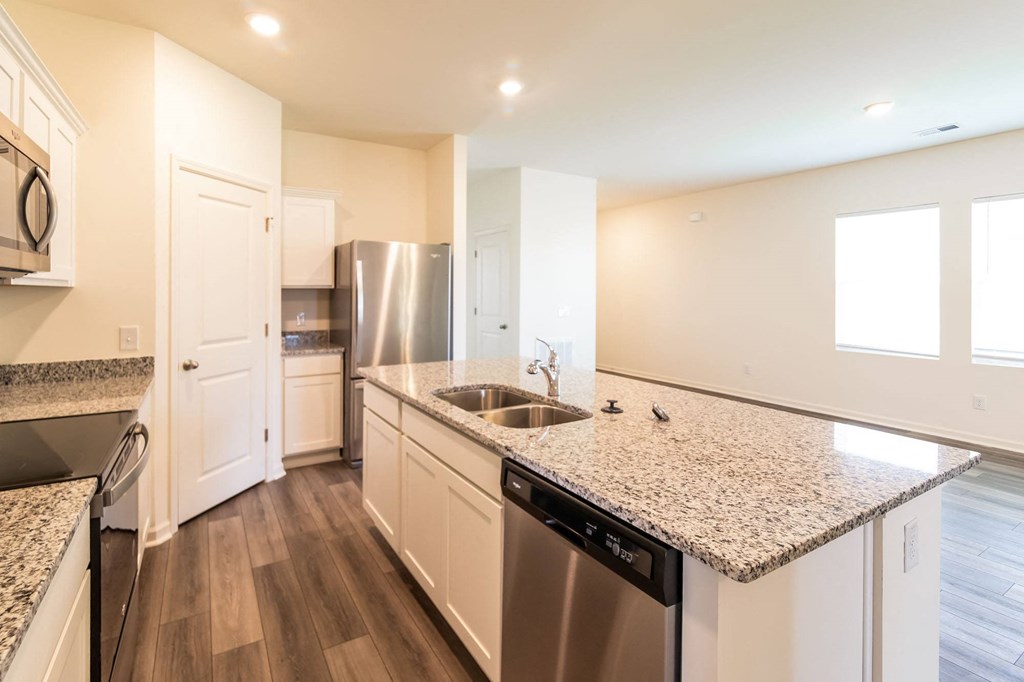 a kitchen with granite counter tops and stainless steel appliances